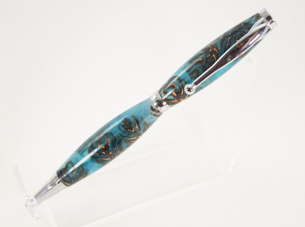 This handcrafted pen is made from (epoxy resin) and pinecones. It provides a firm and comfortable grip. The clip and rings on the cap, barrel, and tip enhance the pen’s beauty. This classic twist pen, the Slimline is an all-time favorite. Quality components like the Swiss-made carbide writing tip make the Slimline pen a fantastic writing choice.