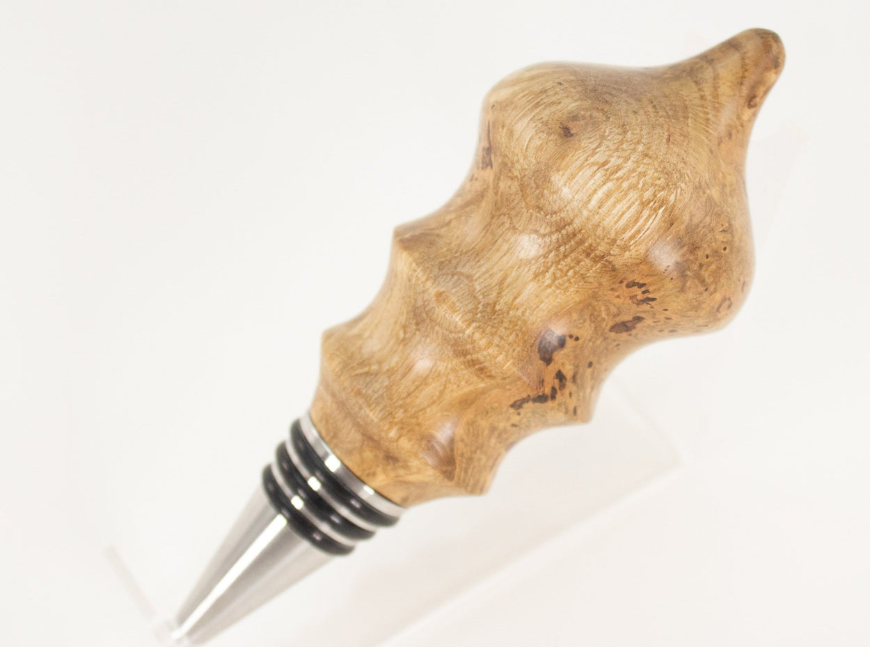 This handmade wooden stopper is made from Black Cherry Burl. This custom one-of-a-kind wooden wine stopper was turned from a burl that was harvested next to the Kennebec River in Maine.