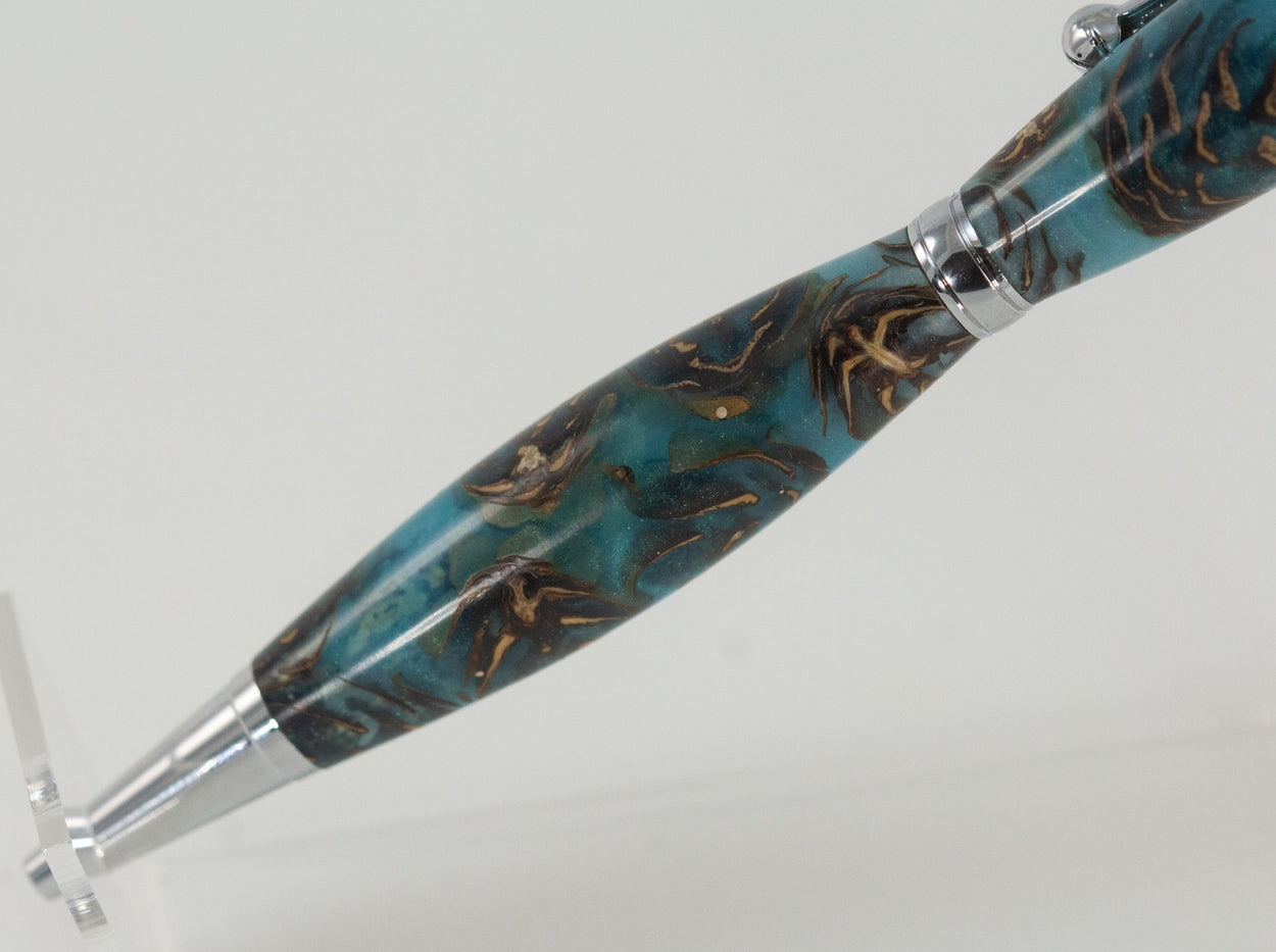 This handcrafted pen is made from (epoxy resin) and pinecones. It provides a firm and comfortable grip. The clip and rings on the cap, barrel, and tip enhance the pen’s beauty. This classic twist pen, the Slimline is an all-time favorite. Quality components like the Swiss-made carbide writing tip make the Slimline pen a fantastic writing choice.
