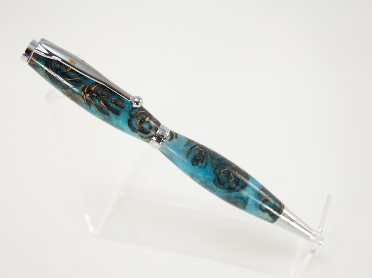 This handcrafted pen is made from (epoxy resin) and pinecones. It provides a firm and comfortable grip. The clip and rings on the cap, barrel, and tip enhance the pen’s beauty. This classic twist pen, the Slimline is an all-time favorite. Quality components like the Swiss-made carbide writing tip make the Slimline pen a fantastic writing choice.