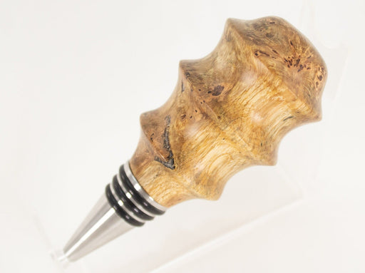 This handmade wooden stopper is made from Black Cherry Burl. This ​custom one-of-a-kind wooden wine stopper was turned from a burl that was harvested next to the Kennebec River in Maine.