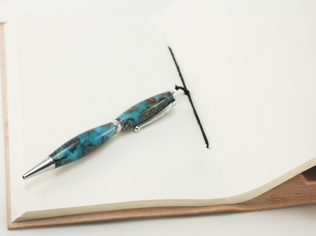 This handcrafted pen is made from (epoxy resin) and pinecones. It provides a firm and comfortable grip. The clip and rings on the cap, barrel, and tip enhance the pen’s beauty. This classic twist pen, the Slimline is an all-time favorite. Quality components like the Swiss-made carbide writing tip make the Slimline pen a fantastic writing choice.